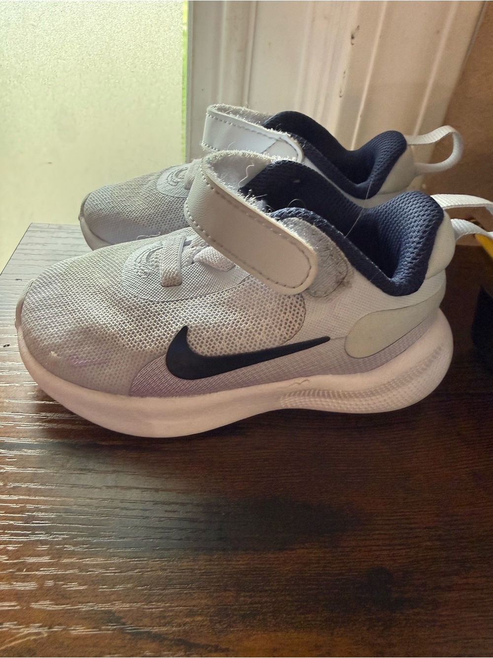Nike Kids White Sneakers with Black Swoosh and Navy Lining